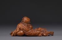 Japan - Boxwood sculpture of a reclining old man, late 19th century.