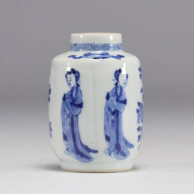 A small white and blue vase decorated with flowers and women in traditional dress from the Kangxi period (1661-1722) with a mark under the piece