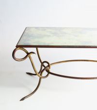 René DROUET (1899-1993) Gilded wrought iron coffee table with eglomised glass top, circa 1940