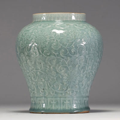 China - Pale green monochrome porcelain vase with floral decoration in relief, blue mark under the piece, 17th century.