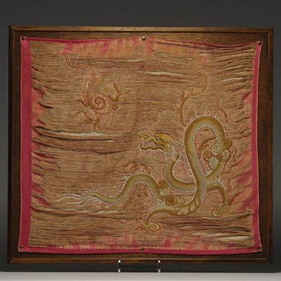 China - Embroidered silk tapestry decorated with a gold dragon on a pink background, late 19th century.