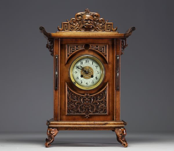 Carved exotic wood clock in the style of Gabriel Viardot with chinoisant decoration, elephant head feet, 19th century.