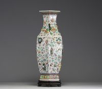 China - A rare pink family polychrome porcelain vase with relief decoration of domestic objects, fruit and floral motifs, hexagonal base, 19th century.