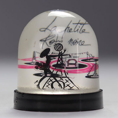 GUERLAIN snow globe representing the Eiffel Tower and the character from 