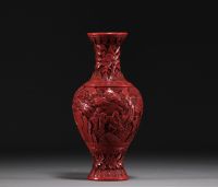 China - An antique cinnabar lacquer vase decorated with figures.