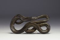 Patinated metal sculpture depicting a snake.