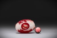 China - Multilayered glass snuffbox decorated with playful characters and bats, carved coral stopper