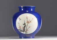 China - A polychrome porcelain vase with a powder blue background and cartouche decoration of birds and flowers, Qing period, 18th century