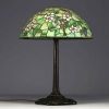 TIFFANY STUDIOS ‘New York’ 1900 - Table lamp with bronze base and floral glass mosaic shade, signed and numbered under the base.