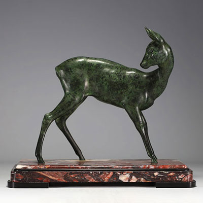Large sculpture of a doe in green patina regula on a pink and black marble base, unsigned.