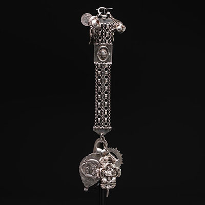 Magnificent large silver chatelaine decorated with various charms, Dutch hallmarks and others.