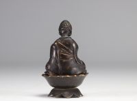 Sculpture of a bronze Buddha resting on a lotus flower from Qing period (清朝)