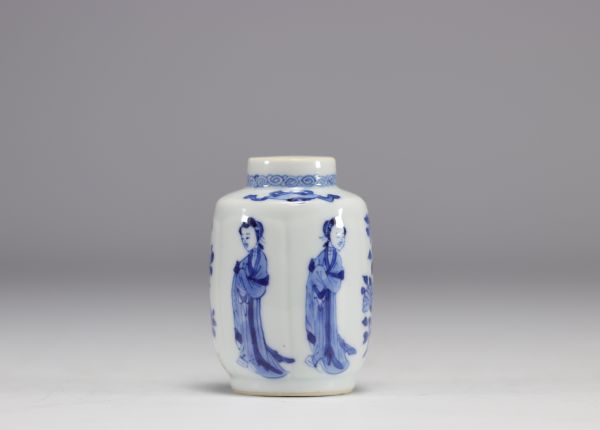 A small white and blue vase decorated with flowers and women in traditional dress from the Kangxi period (1661-1722) with a mark under the piece