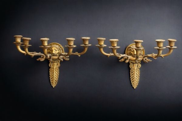 A pair of Empire style ormolu sconces decorated with palmettes and lion heads.