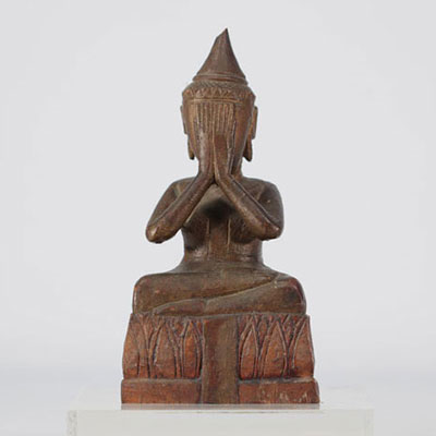 Wooden Buddha hiding his eyes with his hands originating from Thailand