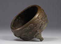 China, bronze perfume burner decorated with phoenixes in clouds, lion-headed feet, Qing period.