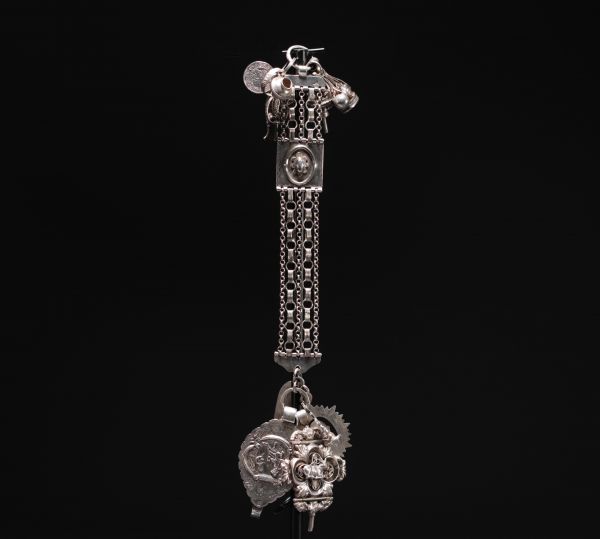 Magnificent large silver chatelaine decorated with various charms, Dutch hallmarks and others.