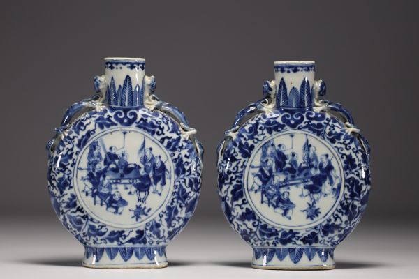 China - Pair of blue-white gourd vases decorated with figures at play, chimera handles, 19th century.