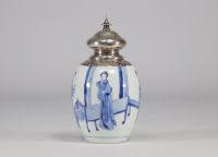 A white and blue vase decorated with women surmounted by a silver stopper with a mark under the piece from the Kangxi period (1661-1722)