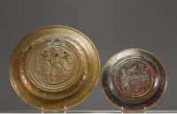 Set of two embossed and repoussé brass offering dishes decorated with religious scenes.