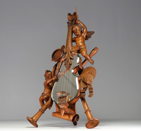 Carved wood violin mirror decorated with cherubs and musical instruments, 19th century.