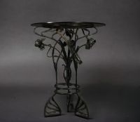 Glass table with floral wrought iron base, Art Nouveau period.