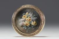 A solid silver snuffbox with a guilloche motif, the lid containing a miniature of flowers.