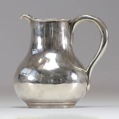 Sterling silver milk jug decorated with coat of arms