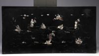 Southern China, Vietnam - A lacquer and mother-of-pearl panel decorated with figures at the water's edge, circa 1900.