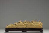 China - Ivory group carved in a tusk, depicting a hunt, silver-veined wooden base, circa 1920-30