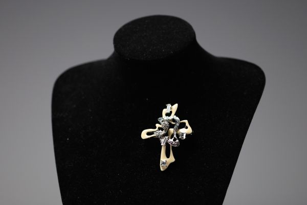 Christian LACROIX - Cross brooch, rhinestones and beige enamel on silver-plated metal, signed.