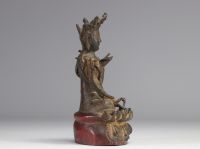 Statue of a traditional seated figure in bronze originating from China from the Ming period  (明朝)