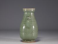 China - Celadon monochrome porcelain vase with floral design in relief.