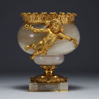 A Louis XVI gilt bronze and agate bowl supported by a cherub.