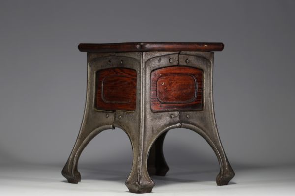 Art Nouveau stool with cast-iron base and mahogany seat.