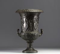 A Medici vase in bronzed brass with a black patina, decorated with a Bacchanalian frieze in the antique style, 19th century.