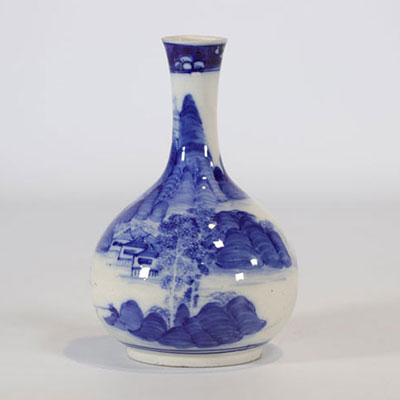 White and blue porcelain vase decorated with a landscape