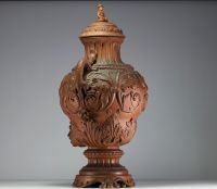 Imposing terracotta wine fountain decorated with scrolls of flowers, chimera-shaped handles, lid surmounted by a Chinese figure.