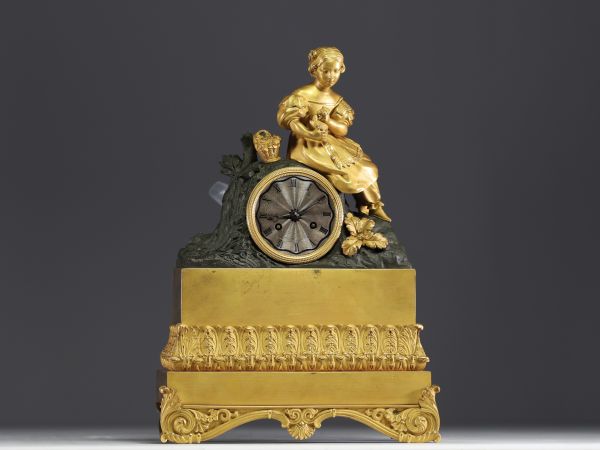 Gilt and patinated bronze clock decorated with Young Girl with Flower Basket, striking movement, Empire period.