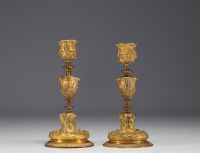 A pair of ormolu candlesticks, decorated with antique figures and goat heads, 19th century.