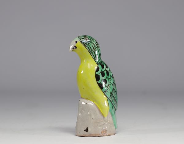 China - Green and yellow glazed ceramic parrot, perched on a rock, Qing period.