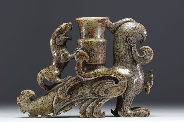 China - A patinated jade vase with a Phoenix design.