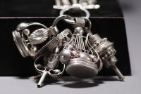 Magnificent large silver chatelaine decorated with various charms, Dutch hallmarks and others.