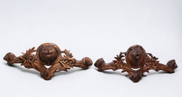 Pair of Black Forest coat hangers decorated with bear heads and edelweiss.