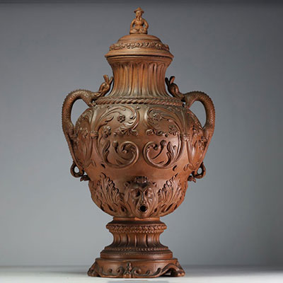 Imposing terracotta wine fountain decorated with scrolls of flowers, chimera-shaped handles, lid surmounted by a Chinese figure.