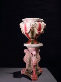 An imposing barbotine pot cover on a column decorated with griffins and lions' heads, circa 1900.