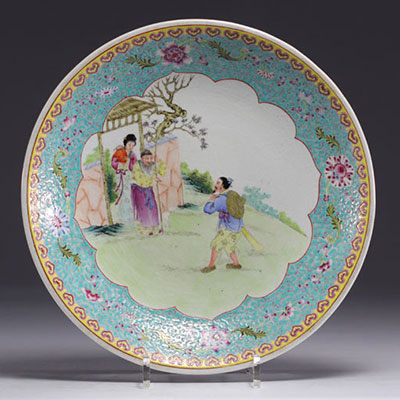 China - Famille rose porcelain plate decorated with figures in a garden, Republic period.