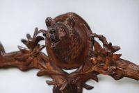 Pair of Black Forest coat hangers decorated with bear heads and edelweiss.