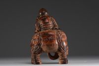 China - Buddha seated on an elephant, sculpture in patinated bamboo.