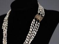 Freshwater pearl set comprising a five-row necklace and a pair of earrings, gold-plated clasp.